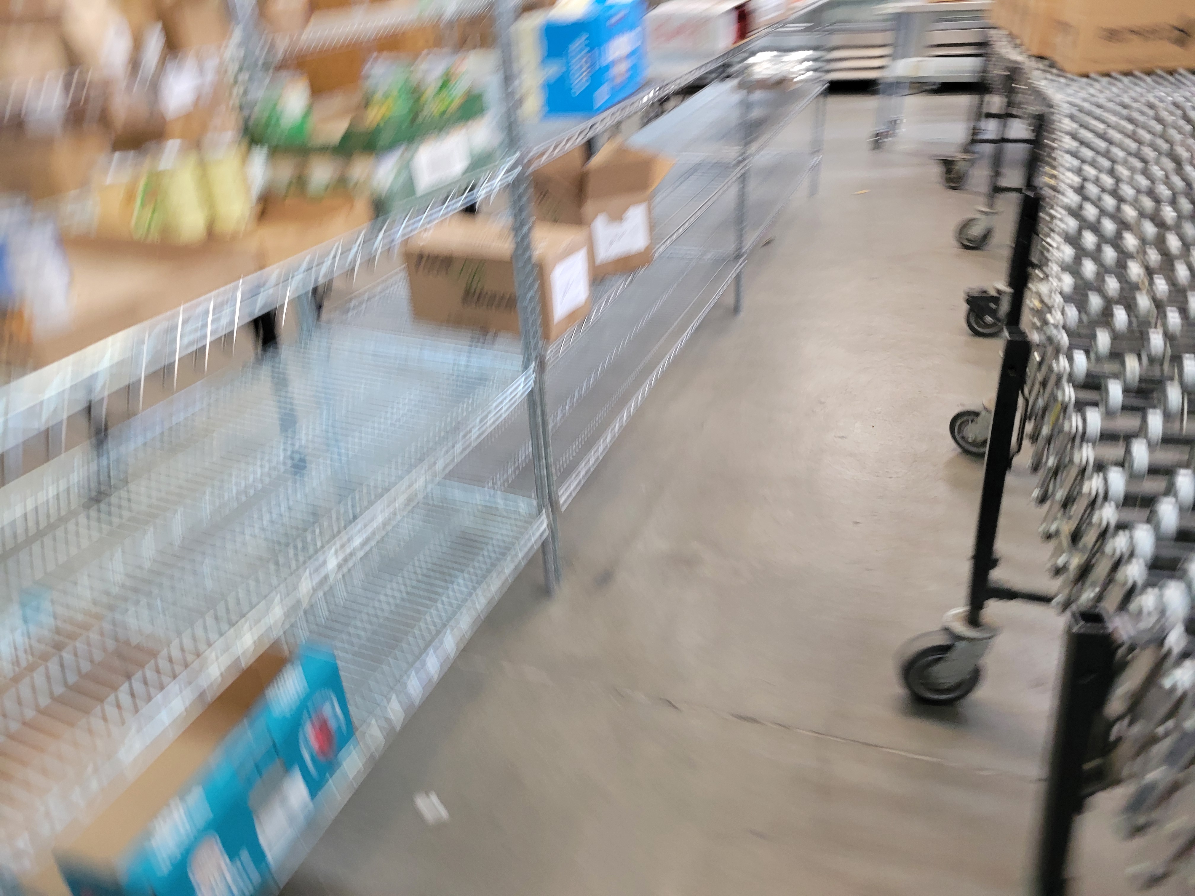 Various food products in shelves to the left and conveyor belt to the right.